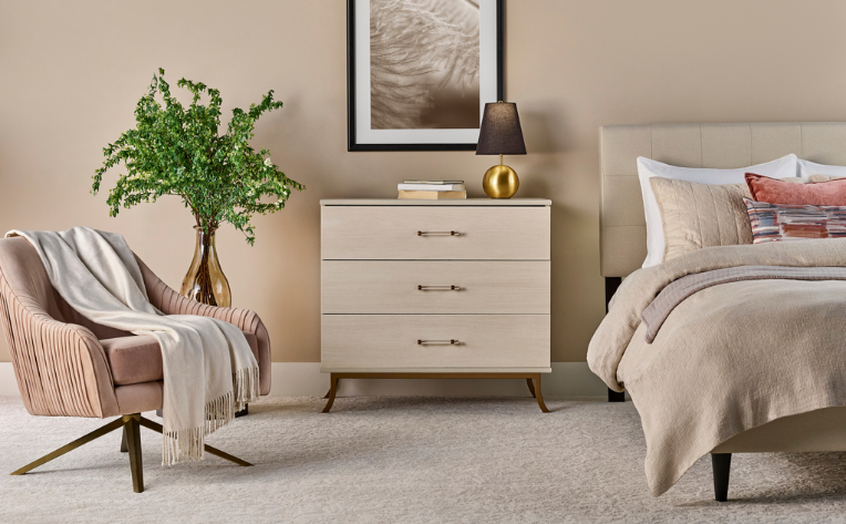 bedroom with beige carpet and blush pink accents